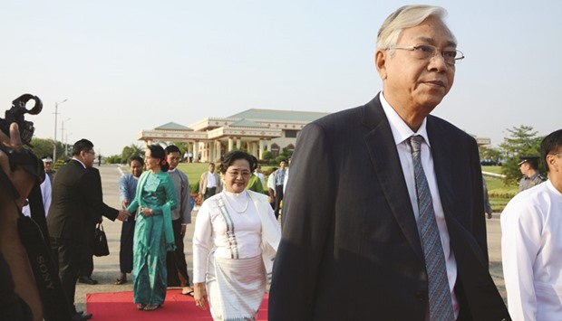 Myanmar President Htin Kyaw (right) followed by First Lady Su Su Lwin (centre, in white dress) and State Counsellor and Foreign Minister Aung San Suu Kyi depart for an official trip to Laos from the Naypyidaw city airport yesterday. The official mission is their first foreign trip after being sworn into office on March 30.