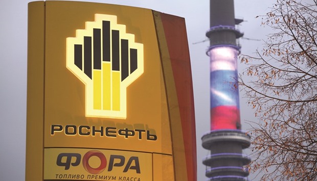 A Rosneft logo sits on an illuminated electronic display board outside the companyu2019s gas station near the Ostankino TV tower displaying the colours of the Russian national flag in Moscow (file). Rosneft, which does not produce LNG itself, said the cargo was bought on the global spot market.