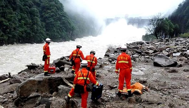 Rescuers search for survivors in the wreckage of a shelter after it was hit by a landslide in Taining county, in Chinau2019s eastern Fujian province on Sunday.  