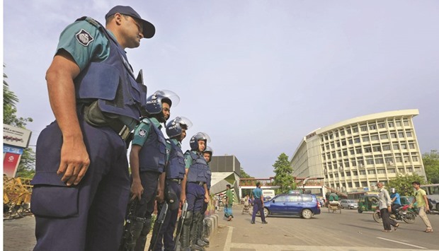 Policemen stand guard on a street during a strike called by Jamaat-e-Islami in Dhaka yesterday.