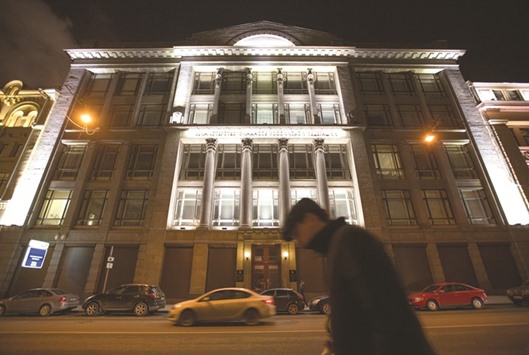 A pedestrian passes the headquarters of Russiau2019s ministry of finance in Moscow. The ministry set a cap of $3bn on its possible borrowing abroad in 2016 after selling $7bn in Eurobonds each year in 2012 and 2013.