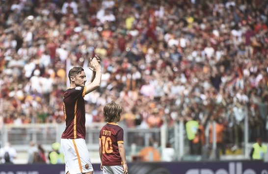 Romau2019s forward from Italy Francesco Totti waves to fans after the Italian Serie A football match Roma vs Chievo at the Olympic Stadium in Rome yesterday.
