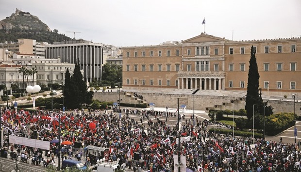 Members of the communist-affiliated PAME union take part in a rally in Athens commemorating May Day u2013 which was postponed due to the Greek Orthodox Easter u2013 and against tax and pension reforms in Athens.