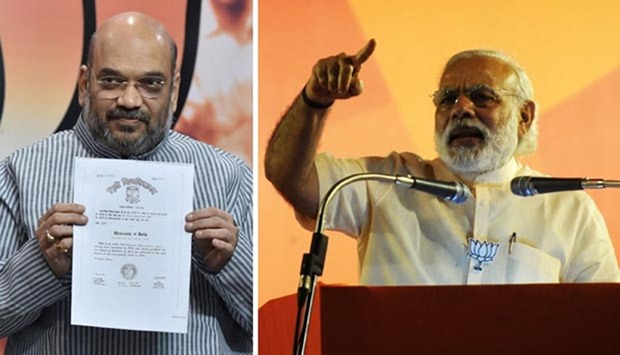 Bharatiya Janata Party president Amit Shah (left) displays the degree certificates of Prime Minister Narendra Modi at a press conference in New Delhi on Monday.