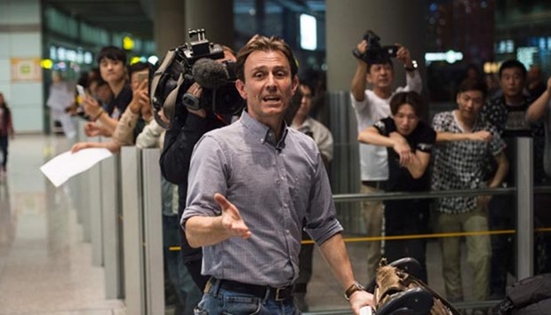 BBC reporter Rupert Wingfield-Hayes speaks to journalists after arriving at the international airport in Beijing on Monday.