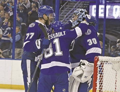 Victor Hedman (No 77), Jonathan Marchessault (No 81) and Ben Bishop (No 30) of the Tampa Bay Lightning celebrate a series win over the New York Islanders at the end of Game Five of the Eastern Conference second round during the 2016 NHL Stanley Cup Playoffs at Amalie Arena in Tampa, Florida. (Getty Images/AFP)