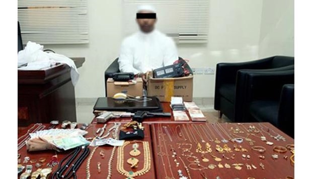 The arrested man with the seized valuables.
