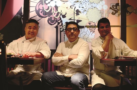 Anjan Chatterjee, centre, flanked by Chefs Lin Hong Bo, left, and Rajesh Dubey at Mainland China, Doha.   Photo by Anand Holla