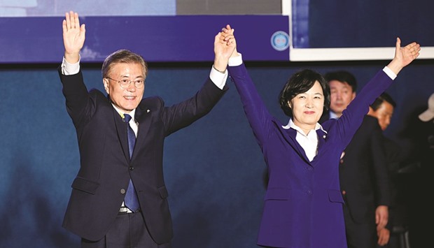 South Koreau2019s presidential candidate Moon Jae-in and leader of the Democratic Party of Korea Choo Mi-ae thank supporters at Gwanghwamun Square in Seoul.
