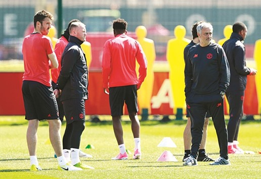 Manchester United manager Jose Mourinho, Wayne Rooney and Michael Carrick during a training session yesterday.