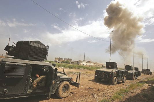 A car bomb explodes as members of Iraqu2019s Counter-Terrorism Services (CTS) advance towards the Al-Islah al-Zaraye neighbourhood, west of Mosul, yesterday.