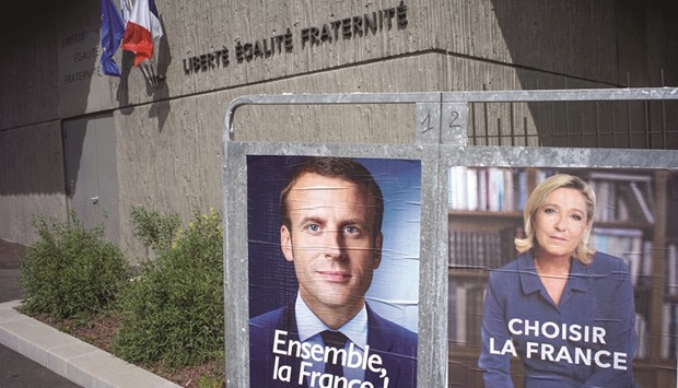 New official posters Macron and Le Pen are displayed in Fontaines-sur-Saone, near Lyon.