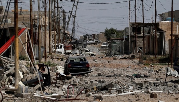 Debris is seen on a street  of Mosul