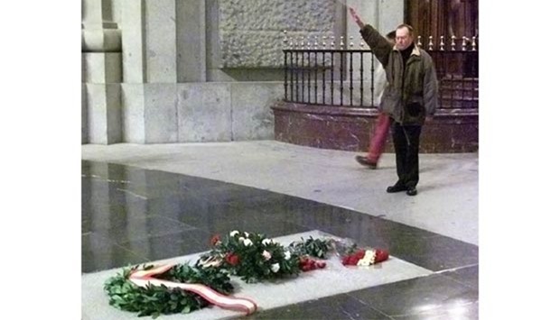 A man does the Fascist salute as he stands in front of Francisco Franco's grave in this file picture.
