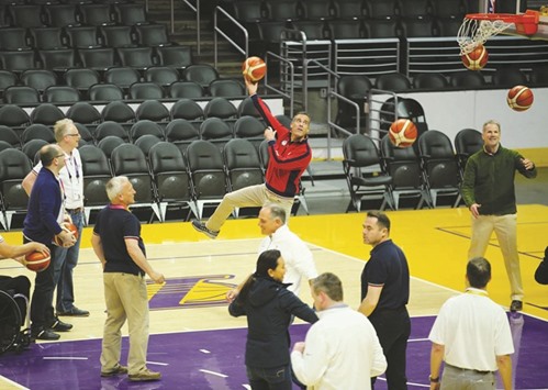 International Olympic Committee Evaluation Commission Chairman Patrick Baumann watches as Los Angeles Mayor Eric Garcetti makes a shot as they tour the Staples Center, home of the Los Angles Lakers, for the LA 2024 bid for the Summer 2024 Olympic Games in Los Angeles, California, yesterday.