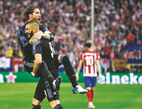 Real Madridu2019s Karim Benzema and Sergio Ramos (left) celebrate their opening goal during the UEFA Champions League semi-final second leg match against Atletico Madrid at the Vicente Calderon stadium in Madrid, on Wednesday night. (AFP)