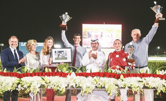 Qatar Racing and Equestrian Club (QREC) vice chief steward Abdulla Rashid al-Kubaisi with the winners of the Al Kharrarah Cup after Umm Qarnu2019s Majeed won the 1850m race at the QREC yesterday. PICTURE: Juhaim
