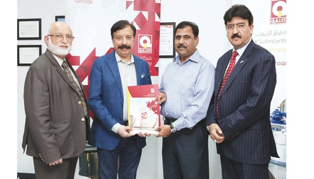 Fawad Rana, Managing Director of Qalco (second left) hands over the sponsorship agreement to Salim Kaiser, tournament co-ordinator of the Qalco cricket tournament 2017.