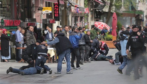 Police officers detain protesters who came to celebrate May Day at Taksim Square in central Istanbul