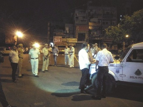 Police carry out investigation at the scene of the shoot-out in Delhi.
