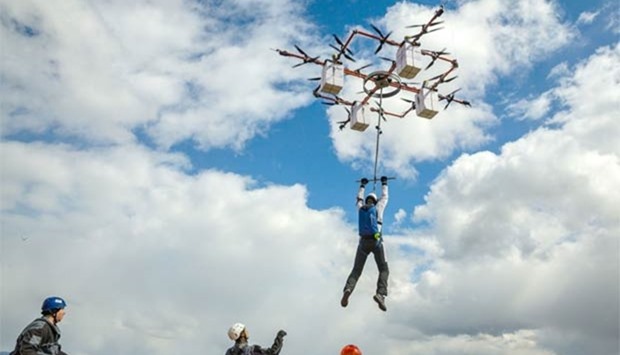 Skydiver Ingus Augstkalns is lifted by a drone from a tower in Taurene, central Latvia.