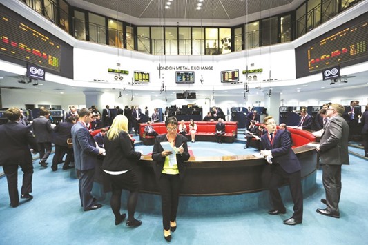 Traders stand outside the open outcry pit following a trading session at the London Metal Exchange. The LME is intent on enticing more investors to halt a slide in trading volumes, but users fear its plans could cause further erosion and even shake the foundations of its benchmark contracts.