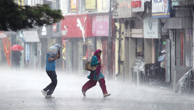 A couple make a dash for cover as heavy rains lash Shimla yesterday.