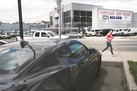Cars are parked in a lot at an auto dealership in New York. The US Commerce Department said retail sales rose 0.4% last month after an upwardly revised 0.1% gain in March.
