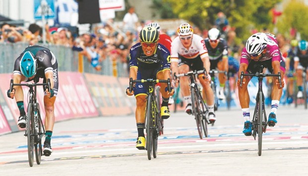 Australiau2019s Caleb Ewan (centre) of the Orica team sprints to win ahead Colombiau2019s Fernando Gaviria (right) of team Quick-Step and Irelandu2019s Sam Bennett (left) of team Bora during the 7th stage of the 100th Giro du2019Italia cycling race. (AFP)