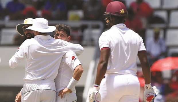 Yasir Shah of Pakistan (centre) celebrates with teammates after taking the wicket of West Indies batsman Shimron Hetmyer (right) at the Windsor Park Stadium in Roseau, Dominica. (AFP)