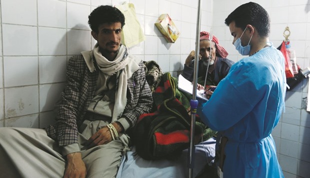 Yemeni men suspected of being infected with cholera receive treatment at a hospital in Sanaa yesterd