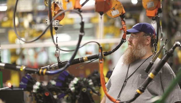 An employee works to manufacture diesel truck engines at the Cummins Mid-Range Engine Plant in Columbus, Indiana (file). The Institute for Supply Management (ISM) said its index of national factory activity dropped to a reading of 54.8 last month, the weakest reading since December, from 57.2 in March.