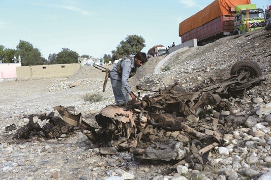 Afghan security forces inspect the site of a suicide attack targeting foreign troops in the Bati Kot district of Nangarhar province yesterday. A suicide bomber rammed his explosive-laden vehicle into an armoured vehicle of foreign forces, in Afghanistanu2019s eastern Nangarhar province officials said. The attack caused no fatalities to foreign forces or civilians, but damaged an armoured vehicle.