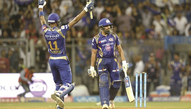 Mumbai Indians captain Rohit Sharma (R) and teammate Hardik Pandya celebrate after winning their match against Royal Challengers Bangalore at The Wankhede Stadium in Mumbai yesterday.