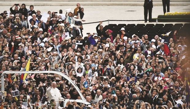 Pope Francis waves to faithful from the Popemobile during his visit to Fatima shrine.