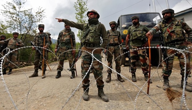 Indian army soldiers stand guard near their army base in Kashmir