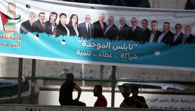 campaign posters displaying an electoral list ahead of municipal elections in  West Bank