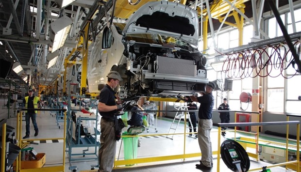 Employees work on the production plant of the French Renault car maker in Sandouville