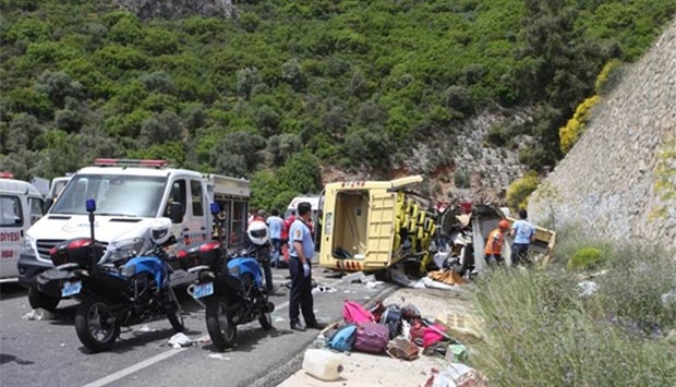 Medics and rescue workers stand at the scene after a tourist bus crashed near the southwestern holiday town of Marmaris in Turkey on Saturday.