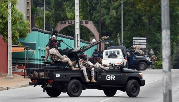 Ivorian soldiers patrol in their vehicle near Ivory Coast's army headquarters in Abidjan on Friday.