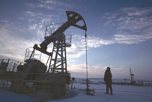 A worker inspects a pumping jack during oil drilling operations in an oilfield operated by Bashneft in Russia. Assuming crude stabilises at around $55 a barrel, government revenue is u201csignificantly more sensitiveu201d to oil prices than volumes, which means the budget stands to gain more even if production stays down under the terms of the agreement, according to Citigroup.