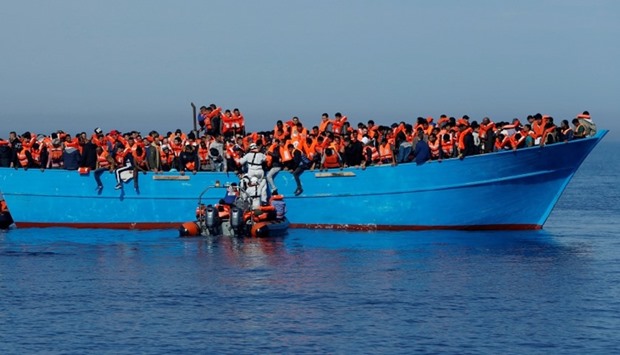 Migrants on a wooden boat are rescued