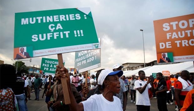 A placard is held during a rally against the mutiny in Abidjan.