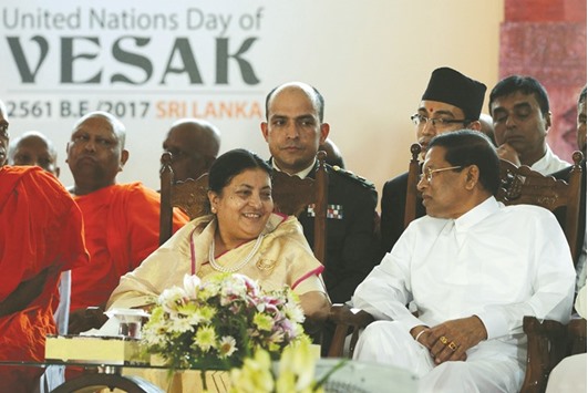 Nepalu2019s President Bidhya Devi Bhandari, left, speaks with Sri Lankau2019s President Maithripala Sirisena as they attend the closing ceremony of an international Buddhist Conference at The Temple of the Tooth in Kandy, some 116kms from Colombo, yesterday.