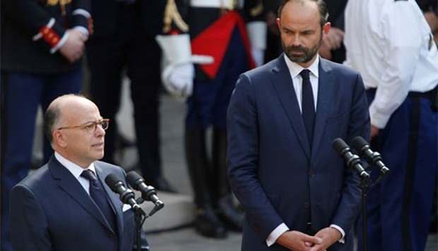 France's outgoing prime minister Bernard Cazeneuve (left) speaks during an official handover ceremony with his successor Edouard Philippe n Paris on Monday.