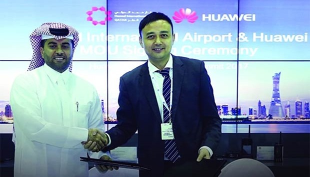 Al-Meer with a senior Huawei executive during the agreement signing.