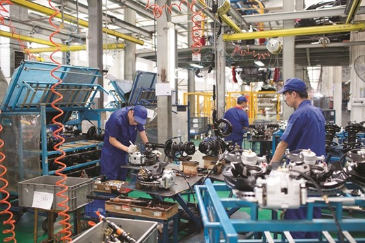 Employees assemble brake pads for BYD Co S6 sport-utility vehicles at the companyu2019s assembly plant in Shenzhen. Chinau2019s growth took a step back in April after a surprisingly strong start to the year, as factory output to investment to retail sales all tapered off as authorities clamped down on debt risks in an effort to stave off a potentially damaging hit to the economy.