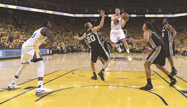 Klay Thompson (C) of the Golden State Warriors looks to pass the ball against the San Antonio Spurs during Game One of the NBA Western Conference Finals.
