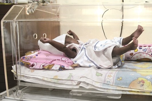 Maryamah Sudigyo, who was born prematurely, plays in an incubator in her home in Bogor.