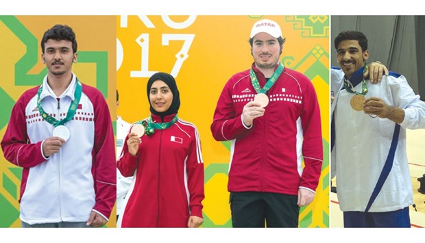 Qatar shooter Ahmed al-Shammari, Qataru2019s Kholoud Hassan al-Khalaf (left) and Mohamed Khejaim  (mixed trap) and Ahmed al-Dayani (gymnastic) celebrates on the podium in the 4th Islamic Solidarity Games yesterday.
